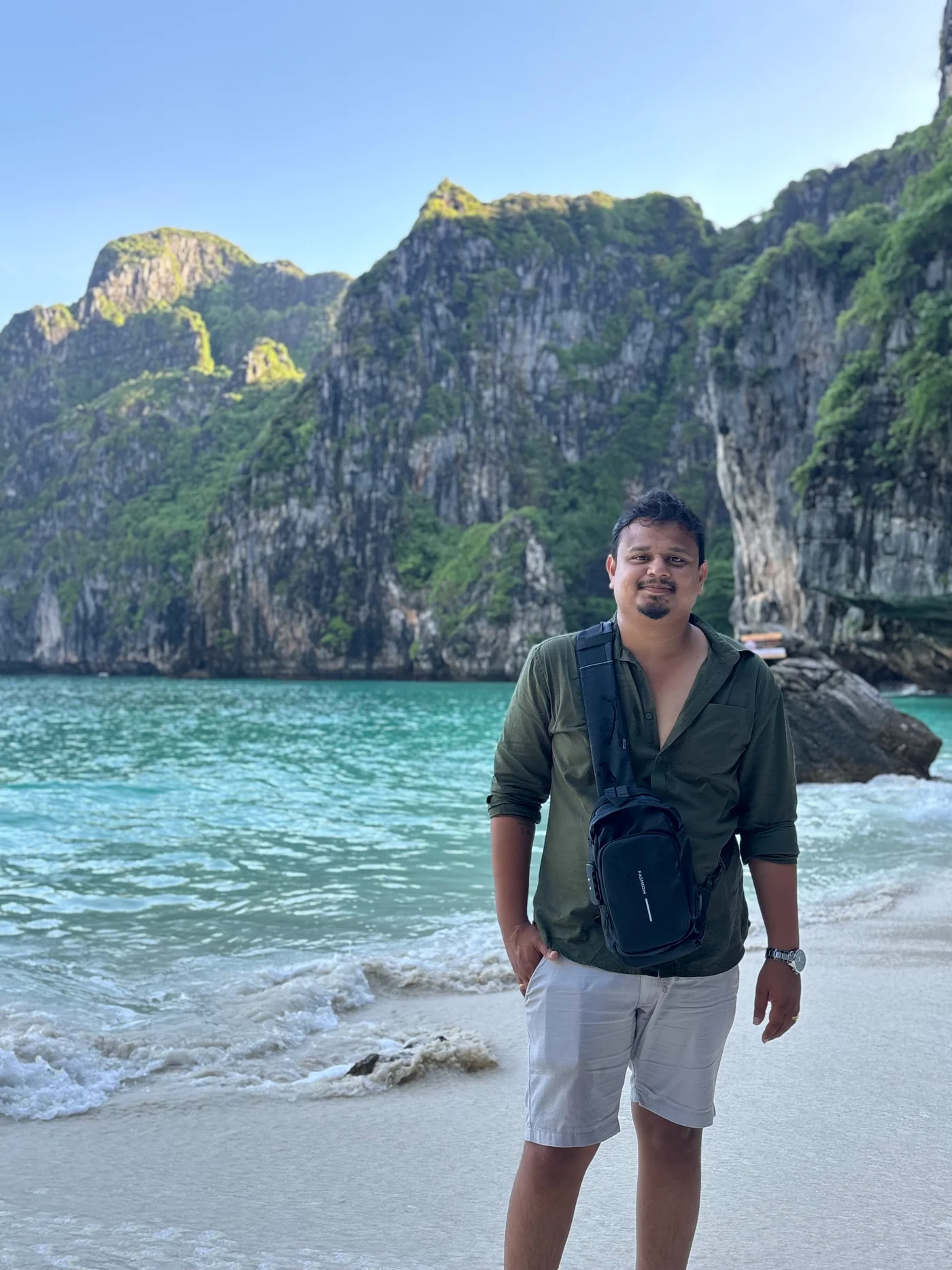 A beach portrait with limestone cliffs and turquoise water