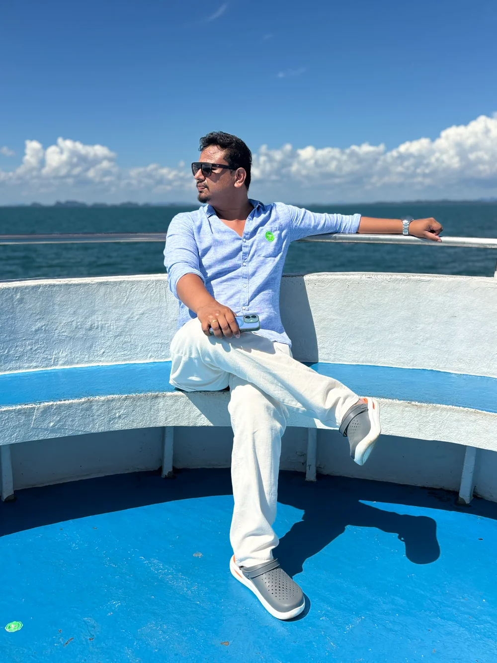Sitting on a boat in Goa with the open sea behind